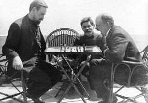 Bogdanov plays chess with Lenin while Maksim Gorky looks on (1908)