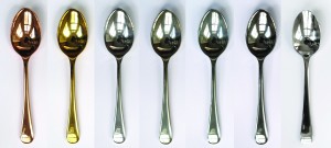From left to right: copper-, gold-, silver-, tin-, zinc-, chrome-, and stainless steel-plated spoons. Photograph by Zoe Laughlin.