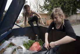 Freegans landing from above on a dumpster. Photo credit: Ben Nelms